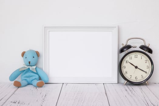 White frame with bear and clock photo