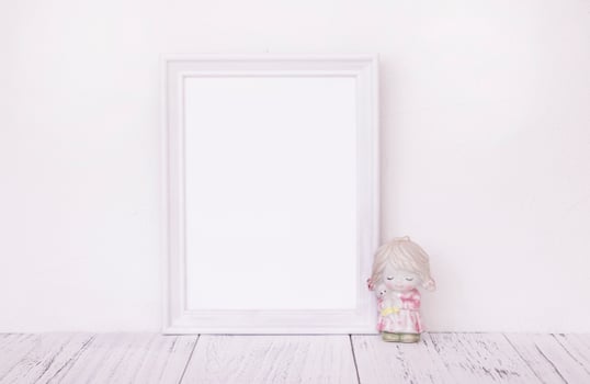 White frame with ceramic figurine photo