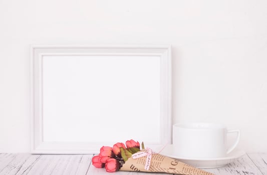 White frame with flowers and coffee photo