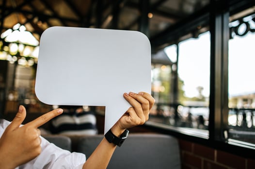 woman holding speech bubble rectangle with conners rounded photo
