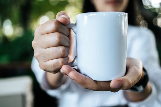 white cup on hand in relax time photo