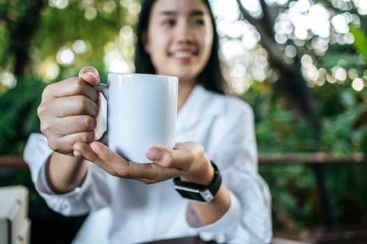 white cup on hand in relax time photo