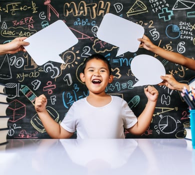 Child acting with speech bubble in the classroom photo