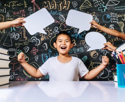 Child acting with speech bubble in the classroom photo