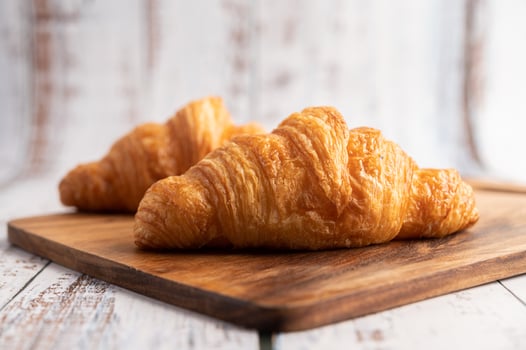 Croissants on a wooden cutting board. Selective focus. photo