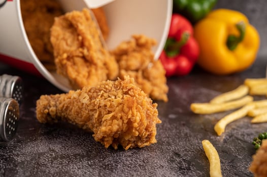 Fried Chicken and French Fries on Black Cement Floor. photo