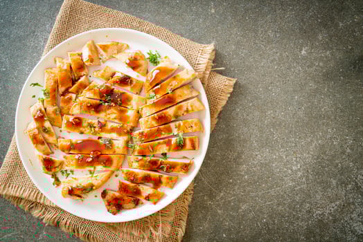 Grilled chicken breast sliced on plate photo