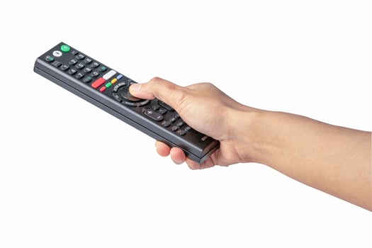 Asian lady holding remote TV television on white background photo