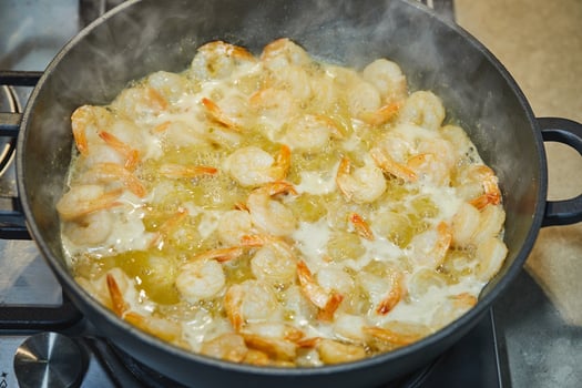 Oil-fried prawns in a pan, top view photo