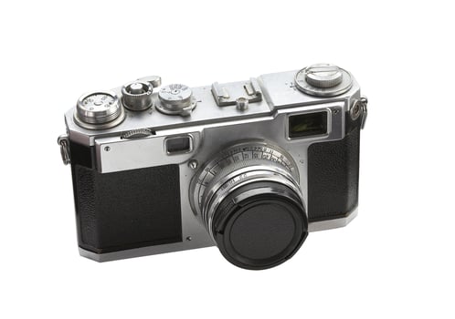 Old film camera on white background photo