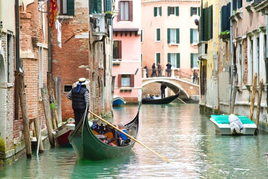 Traditional Venice Cityscape with narrow canal, gondola photo