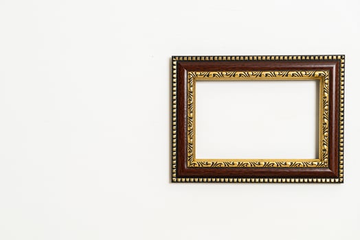 Empty picture frame on white wall background photo