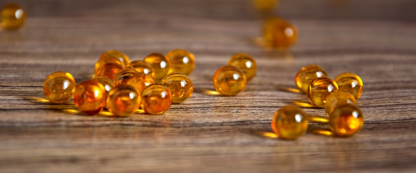 Omega-3 fish oil. Tablets on the table. Wooden background photo