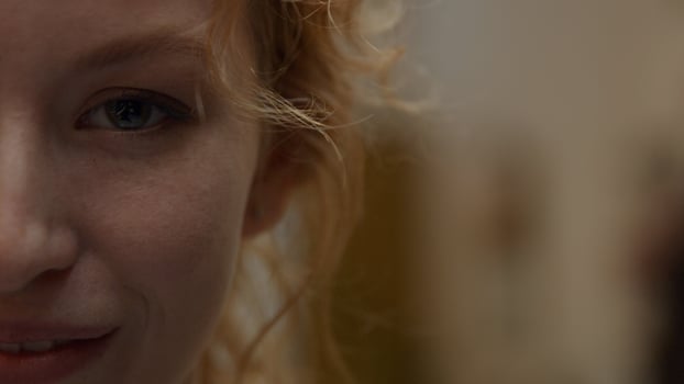 Close up of face of right part of young white woman who laughs photo
