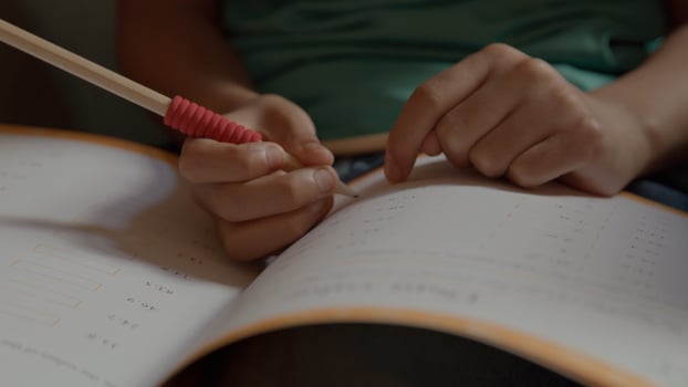 Boy doing maths in armchair photo