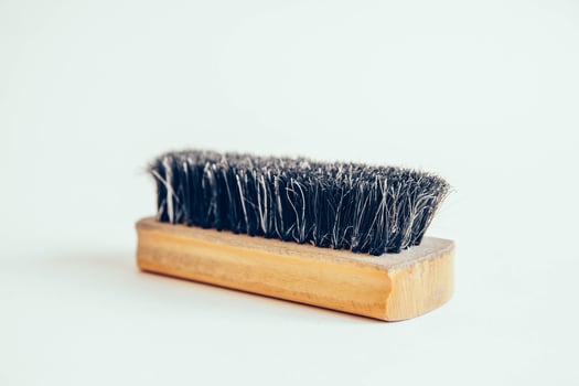 Wooden brush for clothes on a white background photo