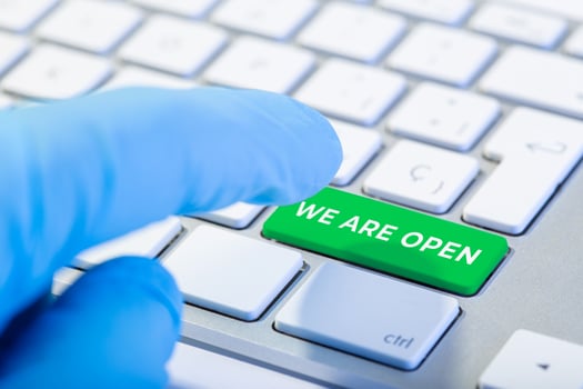 We are open concept. Hand with protective glove photo