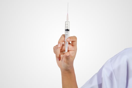 Doctor holding medical injection syringe photo