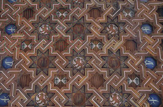 Decorative wooden ceiling with medieval coats of arms and emblems. photo