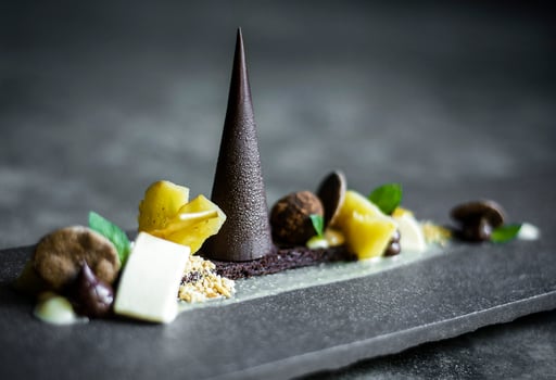 gourmet modern deconstructed chocolate cake and dried fruit dessert dish photo