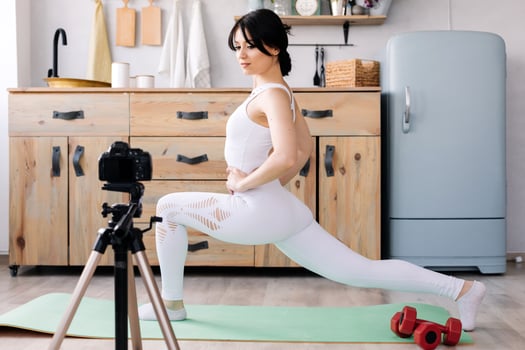 Blogger shoots a video of her workout photo
