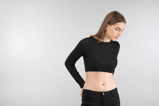 Portrait of  sexy   girl posing in the studio in the black  top.Looking down photo