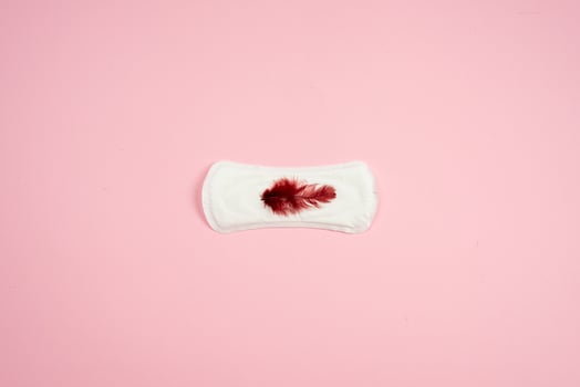 Hygienic liner isolated on pink background. photo