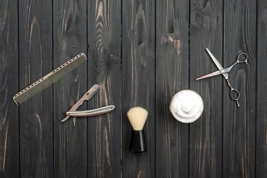 Shaving accessories on a wooden texture background. Tools. Shaving, brush, foam hazard razor. photo