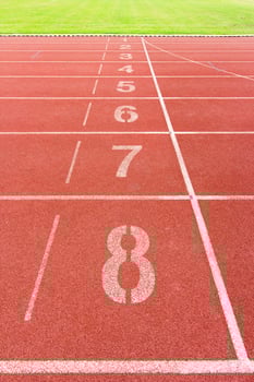 Numbered running track in stadium photo