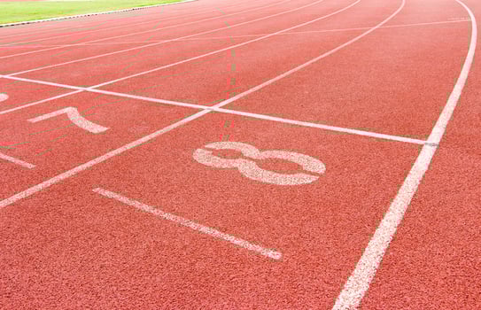 Numbered running track in stadium photo