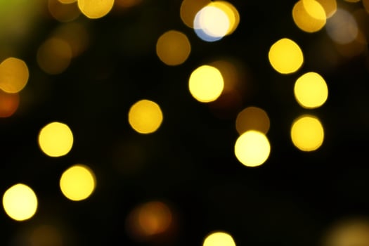 Long exposure blurred yellow christmas tree lights abstract background photo