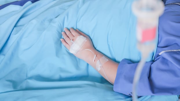 Patient in hospital with saline intravenous IV, saline into the body for treatment photo