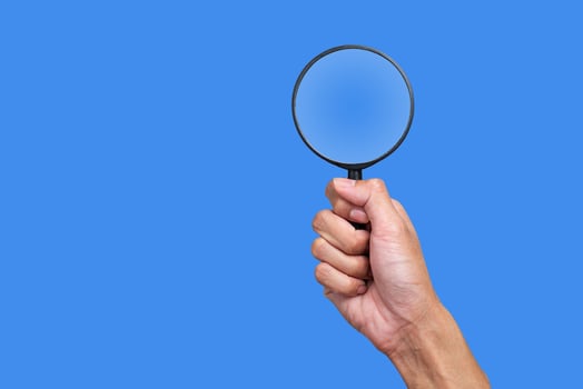 Magnifying glass in hand and looking photo