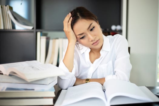 Asian businesswoman and women student serious about the reading book and work hard done until the headache photo