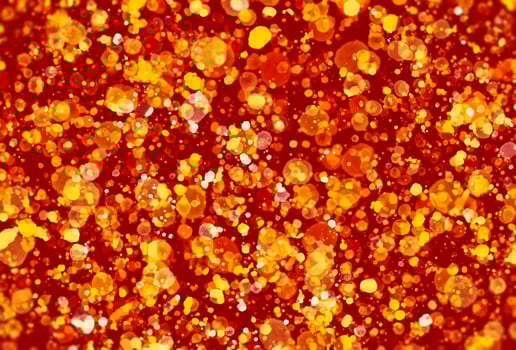 glitter gold particles on red background. photo
