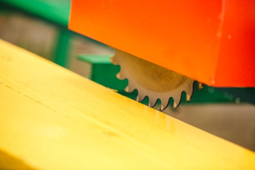 wood cutting machine. Close up electric circular saw cutting wood and iron ruler. photo