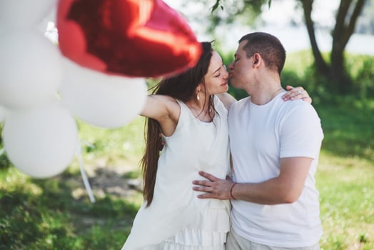 Happy and young pregnant couple hugging in nature. Romantic moments photo