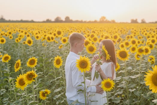 Beautiful couple having fun in sunflowers fields photo