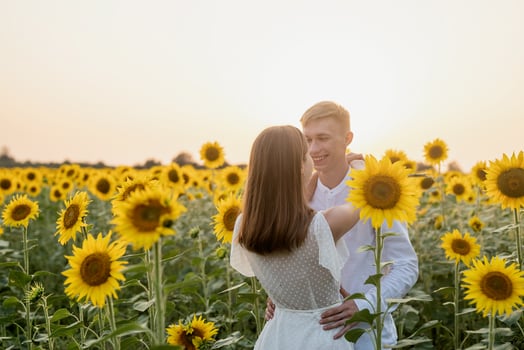 Beautiful couple having fun in sunflowers fields photo