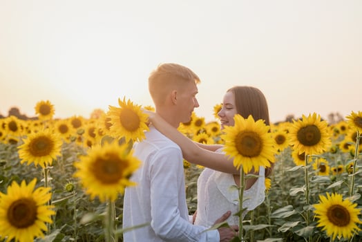 Beautiful couple having fun in sunflowers fields photo