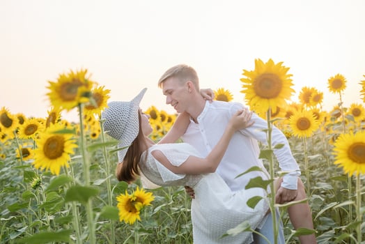 Beautiful couple having fun in sunflowers fields photo