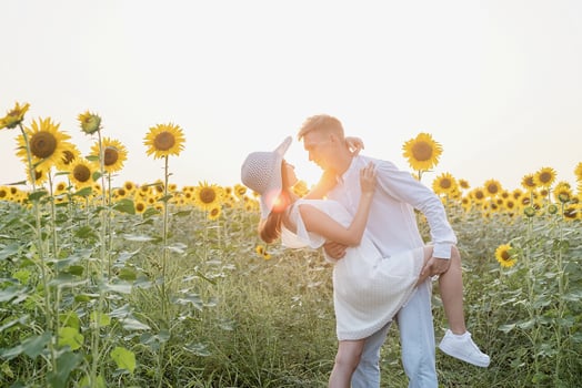 Beautiful couple having fun in sunflowers fields photo