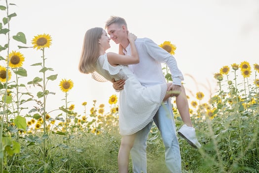 Beautiful couple having fun in sunflowers fields photo