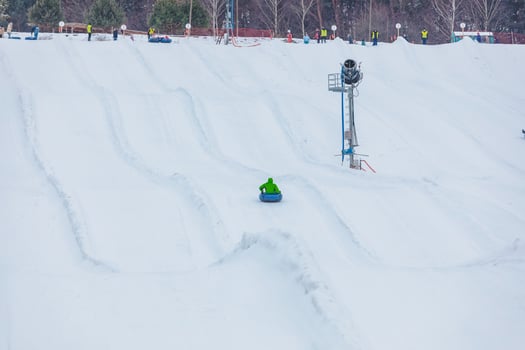 People riding snow tubing at winter park photo