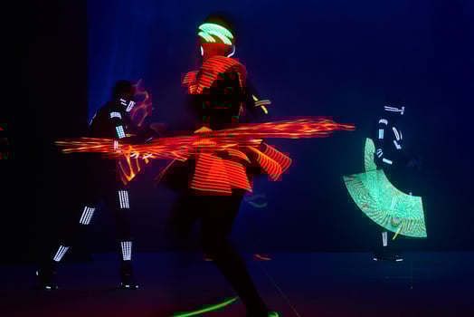Laser show performance, dancers in led suits with LED lamp, very beautiful night club performance, party photo