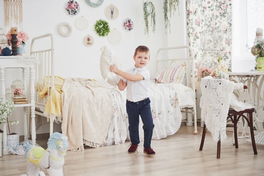 Little boy in white shirt with pillow. Pillow fight photo