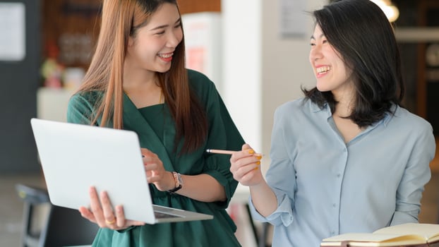 Young business women use laptop to discussing the project together in  modern office with good emotions. photo