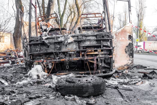 Burnt bus is seen on the street after caught in fire during travel, after fire photo