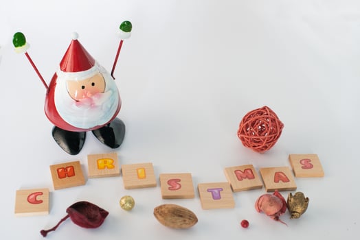 Santa Claus toy, putpourri and the word Christmas in wooden letters photo