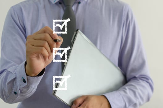 businessman holding a pen with a check mark on the square on a virtual screen photo